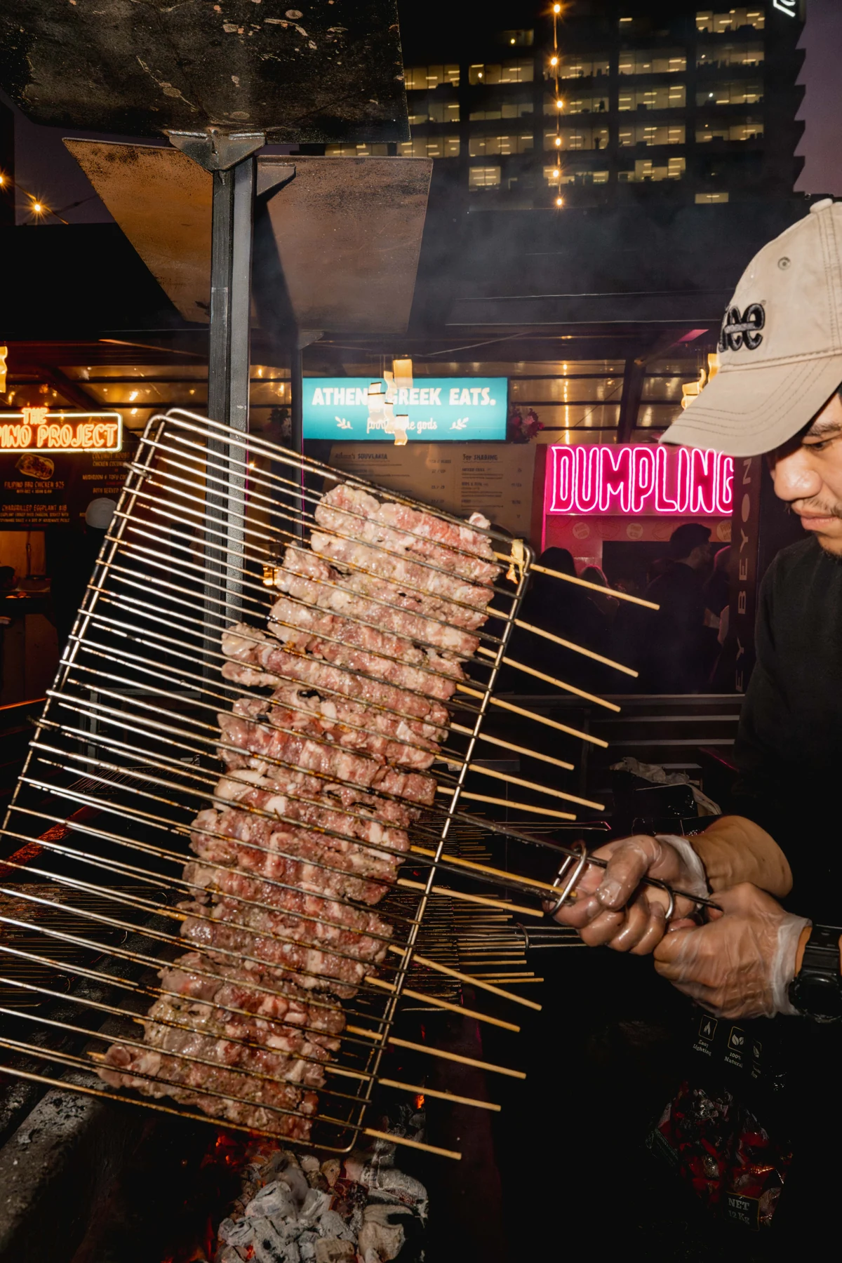 Athena souvlaki skewers cooking over charcoal