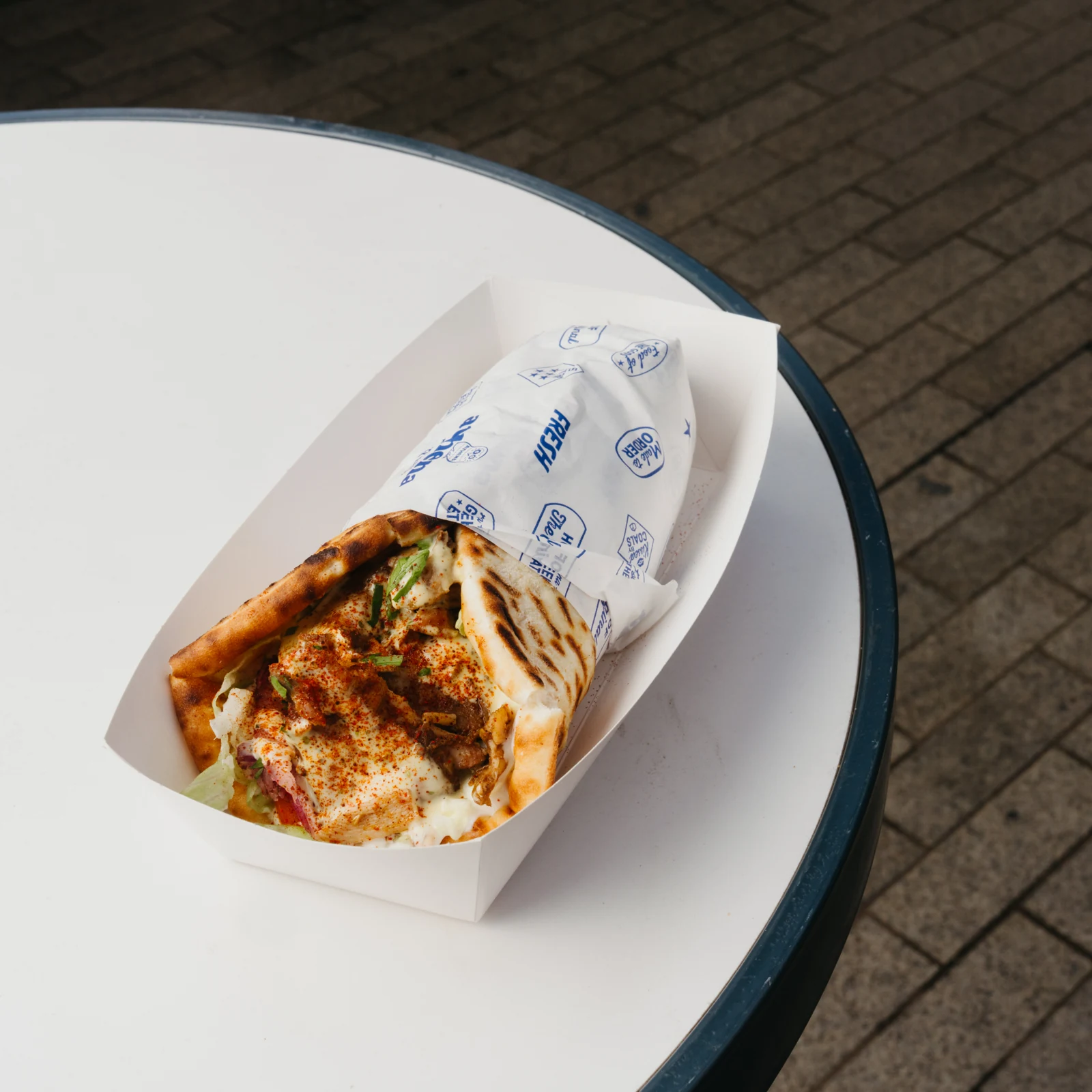 An Athena gyro filled with meat, salad and sauce